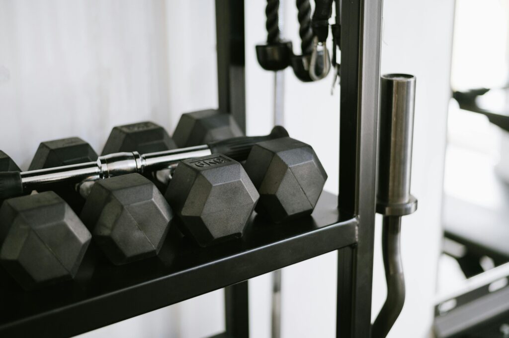 What routine and consistency did to my life and personal finances Close-up of gym equipment including dumbbells on a storage rack, perfect for fitness-themed uses.